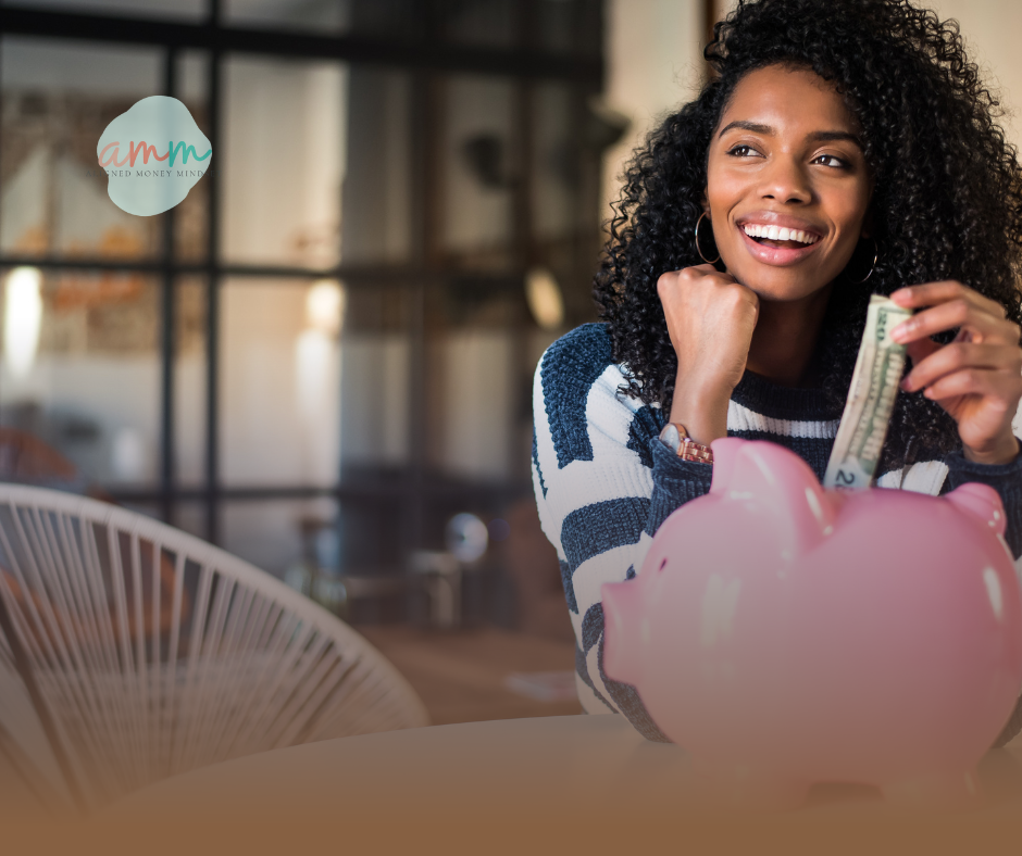 Woman placing money into a piggy bank to illustrate how sinking funds help you save ahead and avoid debt.